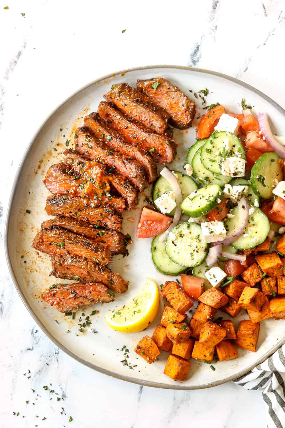 top view of New York Strip recipe on a plate, sliced showing how tender it is