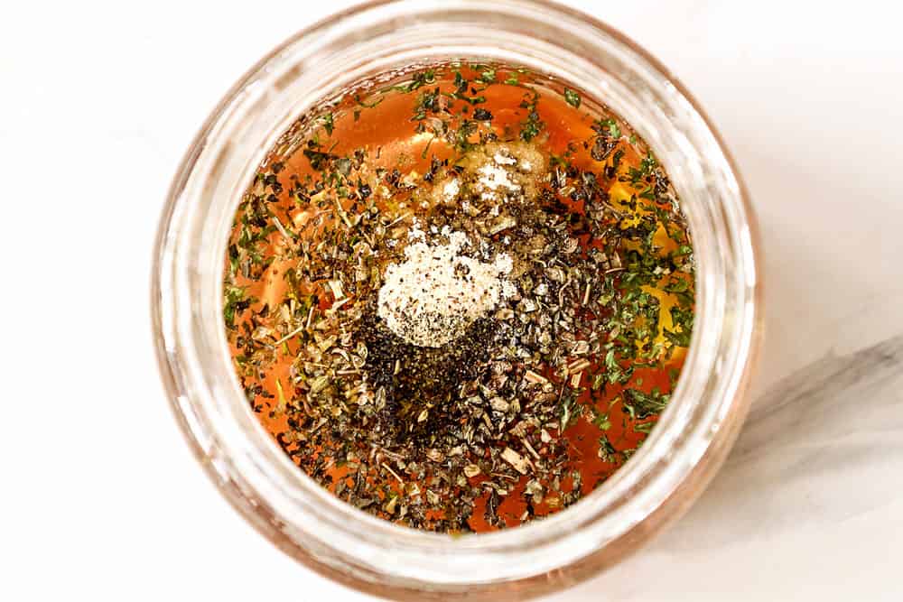 showing how to make Panzanella Salad recipe by whisking the dressing ingredients together in a jar