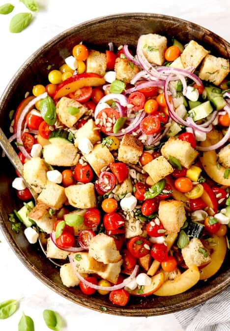 top view of Panzanella in a wood bowl with tomatoes, bread and onions