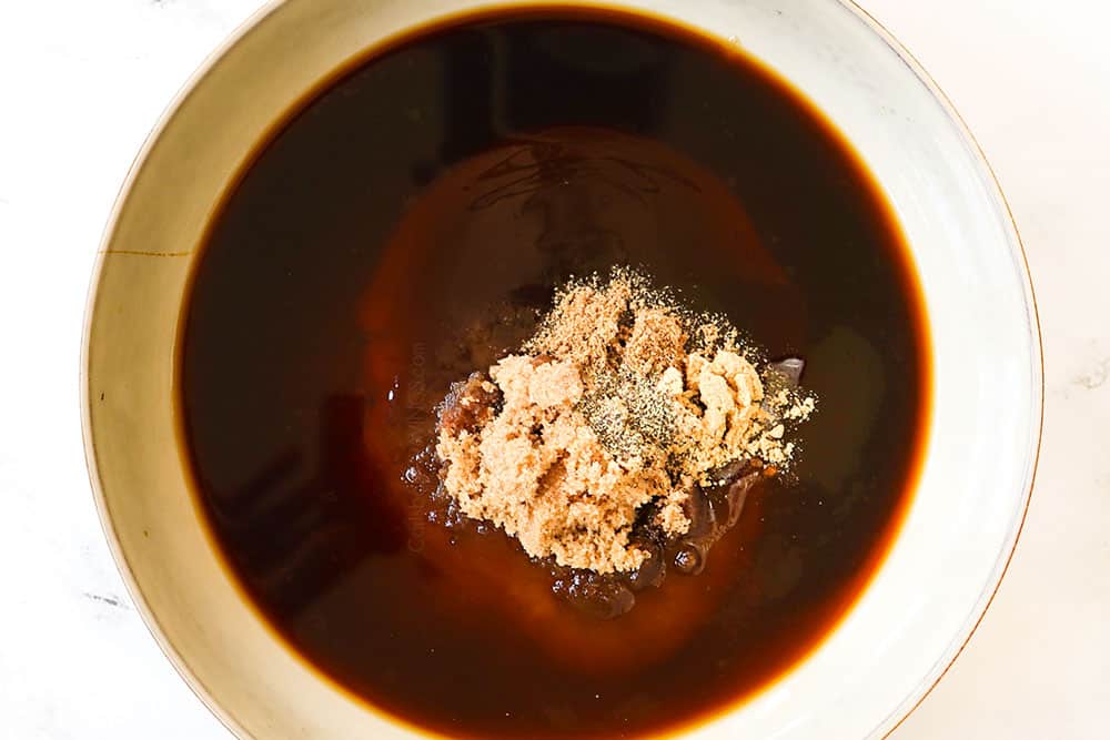 showing how to make Drunken Noodles (Pad Kee Mao) recipe by whisking soy sauce, fish sauce, rice vinegar and brown sugar together in a bowl