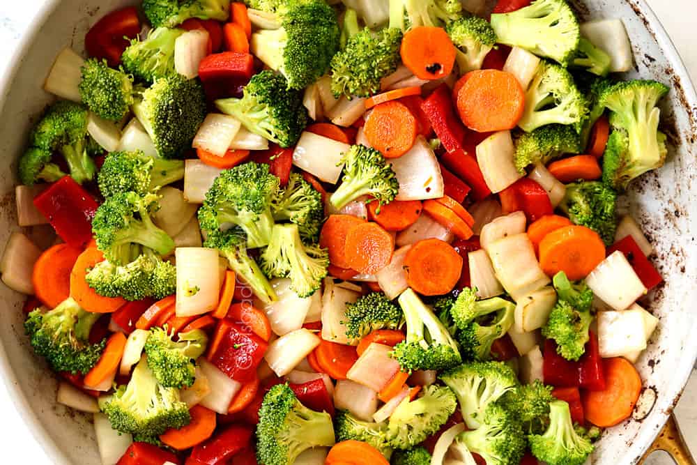 showing how to make honey garlic chicken recipe by stir frying vegetables in a skillet
