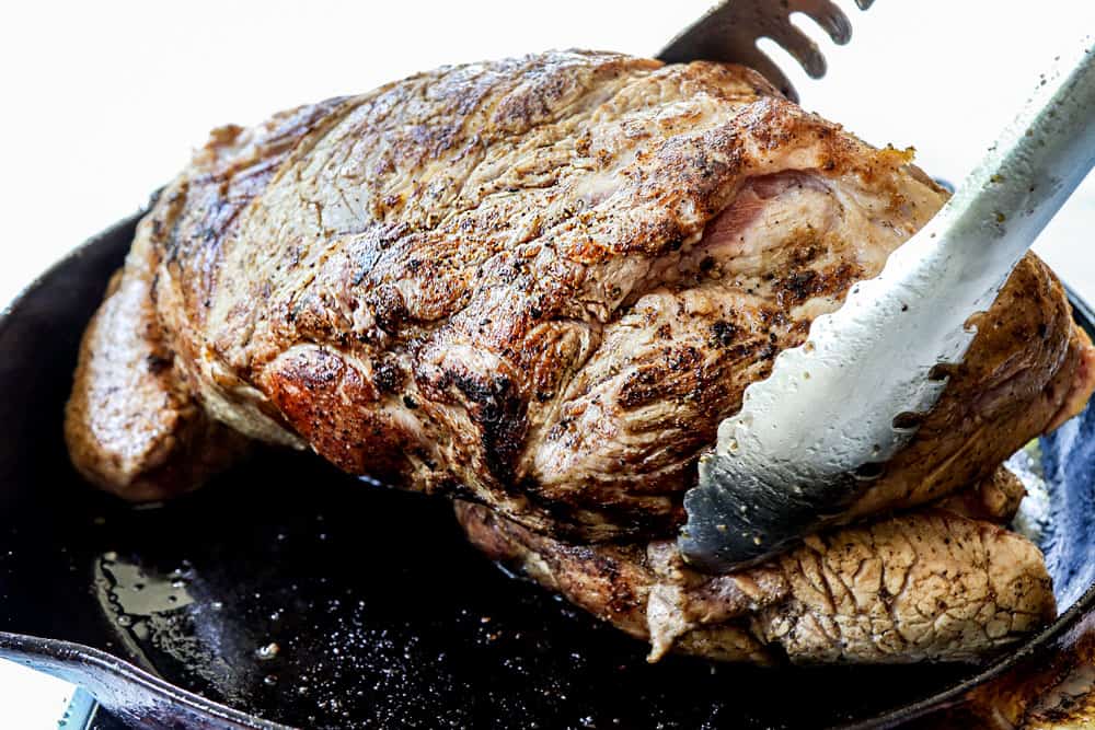 showing how to make Kalua Pork (Kalua Pig) recipe by searing the pork in a cast iron skillet