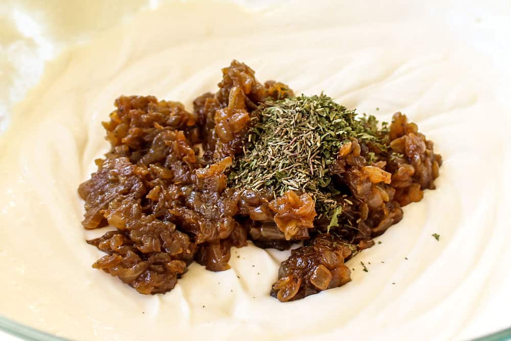 showing love how to make French Onion Dip by adding caramelized onions, parsley, thyme and beef bouillon