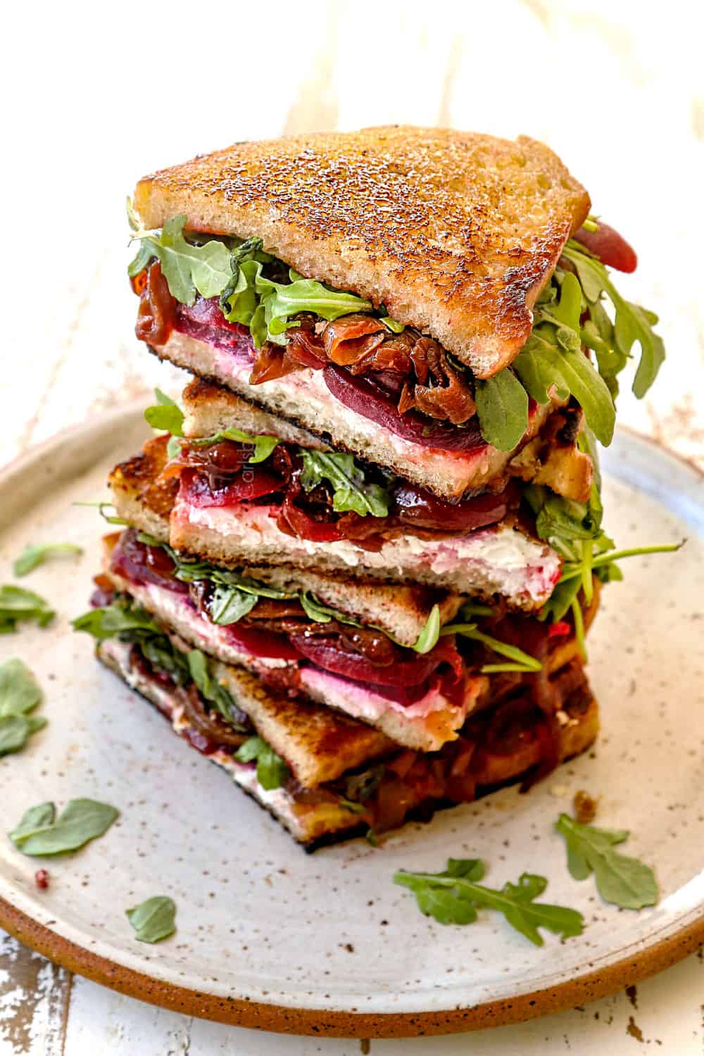 a stack of gourmet grilled cheese sandwiches
