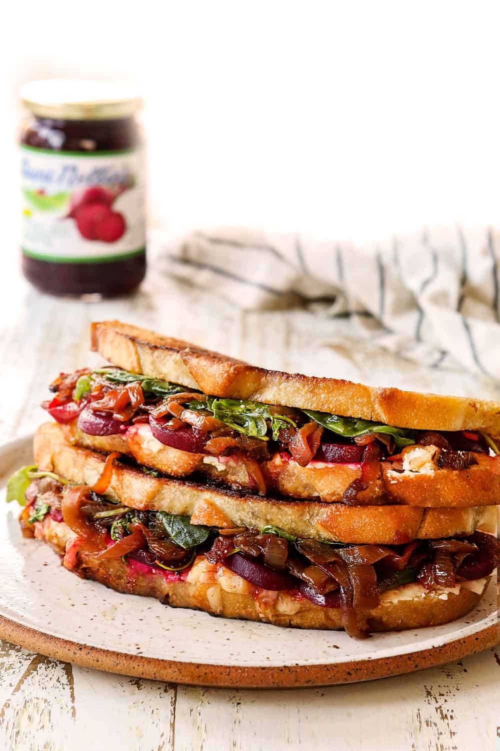 two gourmet grilled cheese sandwiches stacked on top of each other