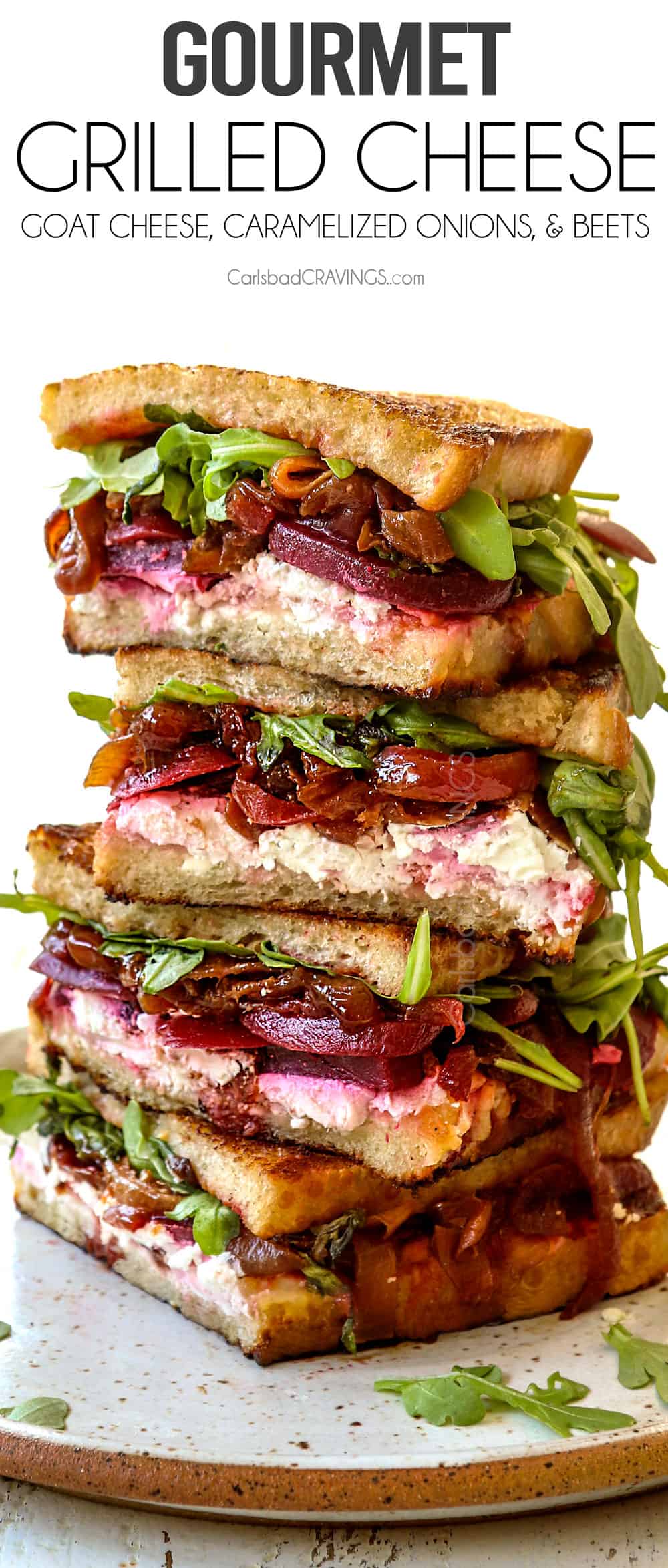 gourmet grilled cheese sliced and stacked with caramelized onions, goat cheese and arugula