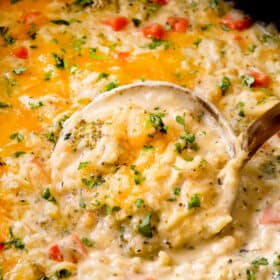 showing how to serve creamy, cheesy crockpot chicken and rice by garnishing it with parsley