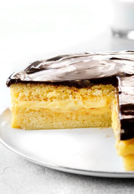 up close of Boston Cream Pie with a slice taken out of it