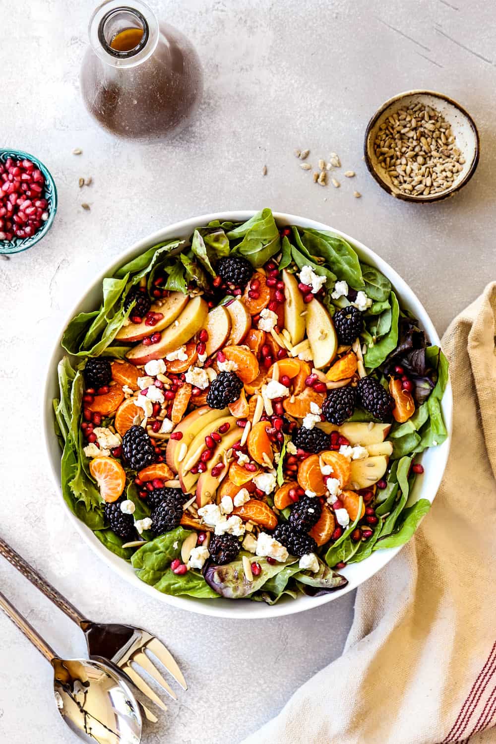 Mandarin Orange Salad with mandarins, apples and blackberries in a white bowl