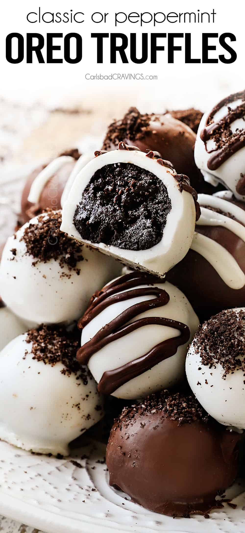up close of Oreo Ball Truffles stacked with a bite taken out showing the inside of the truffle