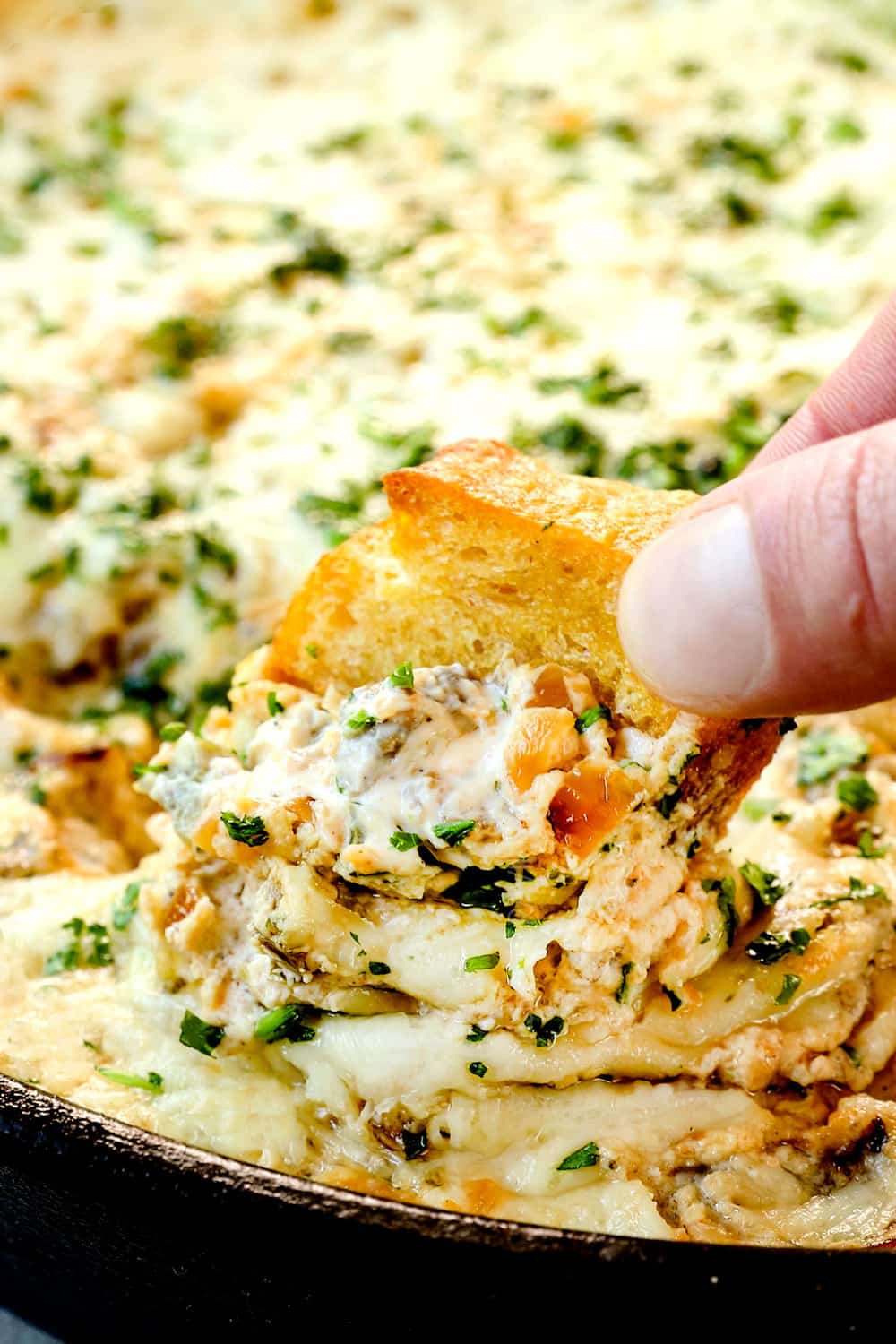 up close of scooping up the hot Philly cheesesteak dip recipe