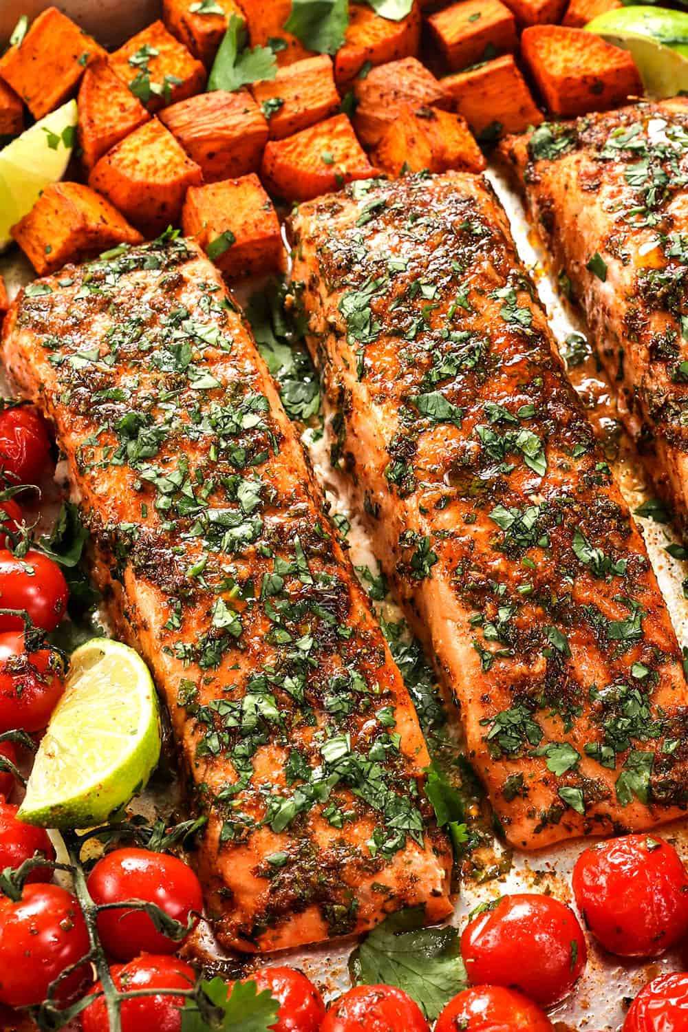 up close of baked salmon fillets on a baking sheet