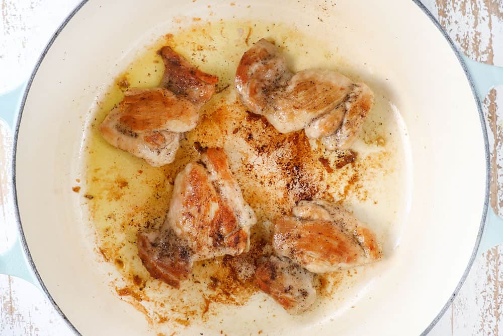 showing how to make creamy chicken noodle soup recipe by searing chicken in a Dutch oven until golden