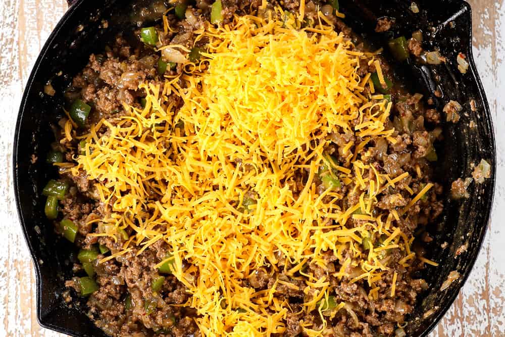 showing how to make Sloppy Joe recipe by adding cheese to the meat filling