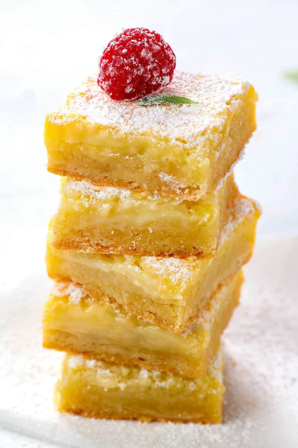 a stock of Ooey Gooey Butter Cake cut into squares