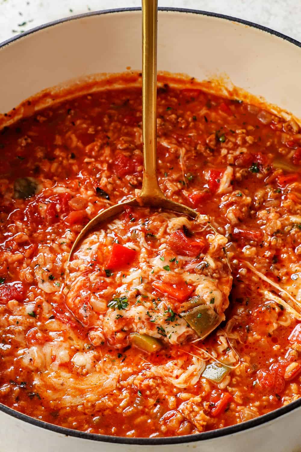 up close of ladle of stuffed pepper soup with sausage and bell peppers