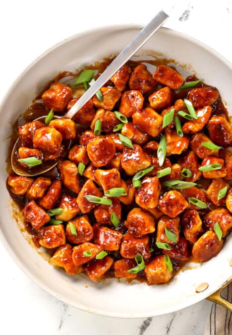 top view of apricot chicken recipe in a skillet garnished by green onions