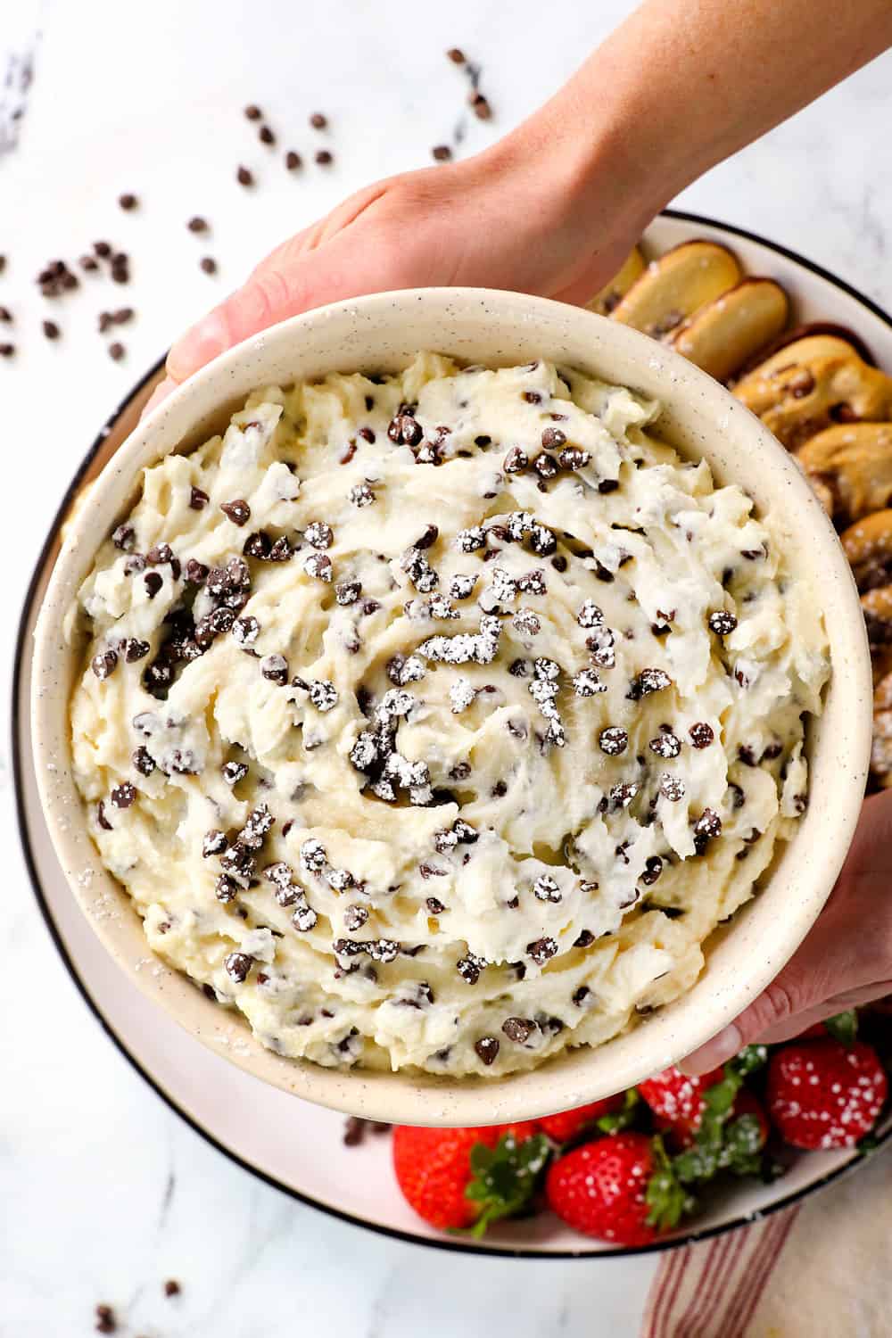 top view of two hands holding cannoli dip recipe showing how creamy it is