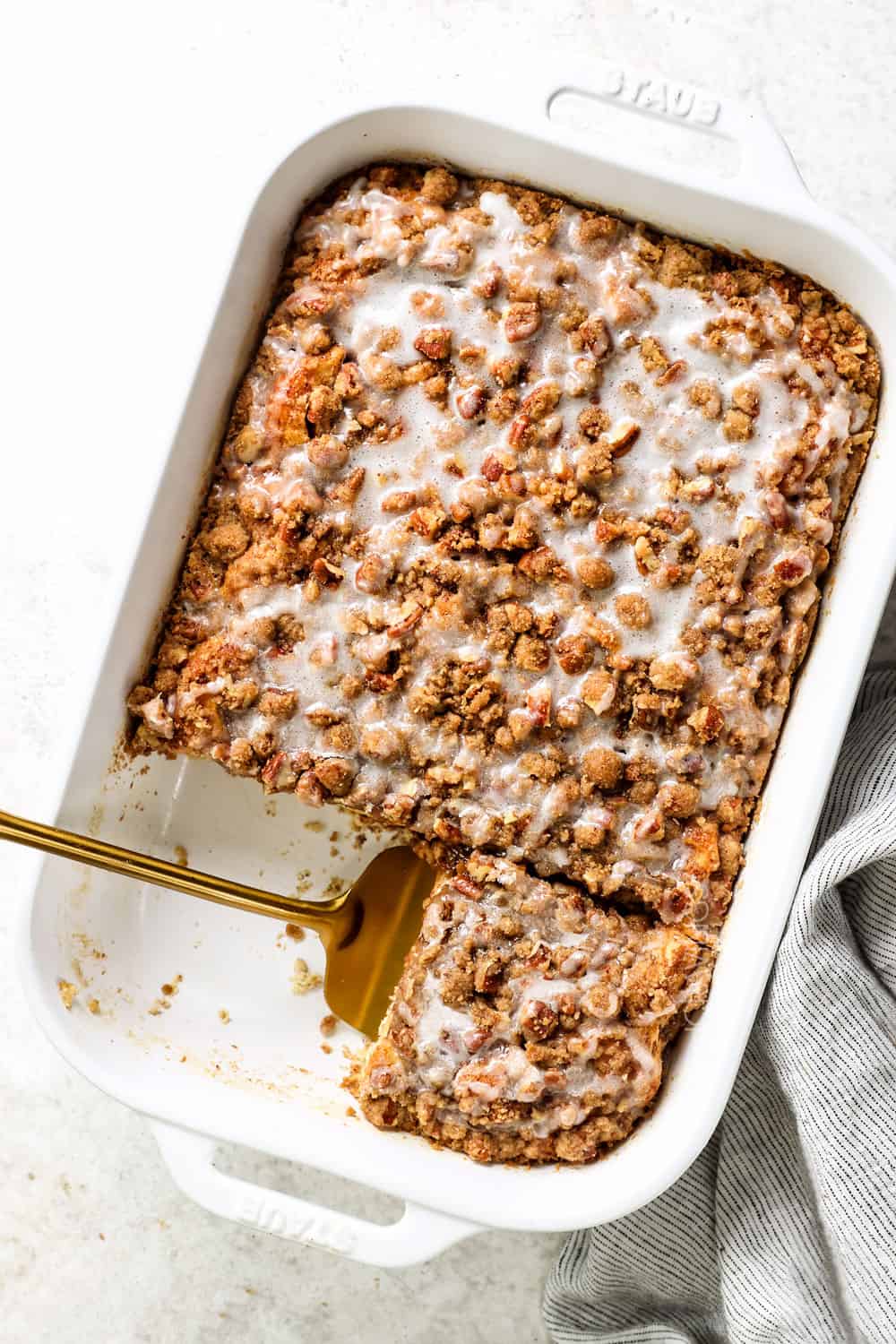 top view of cinnamon roll french toast bake drizzled with icing