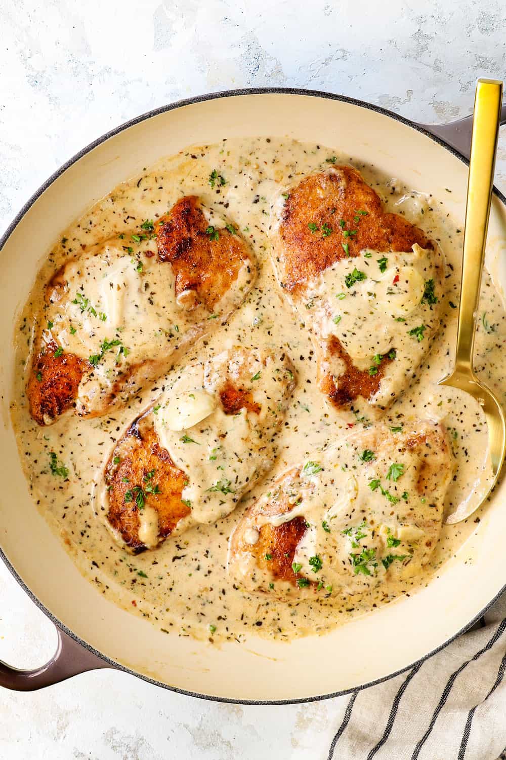 top view of creamy garlic Parmesan chicken in a skillet showing how creamy the Parmesan sauce is