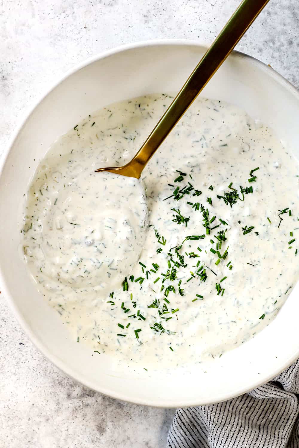 up closer of tartar sauce recipe in a bowl showing how creamy it is with diced pickles