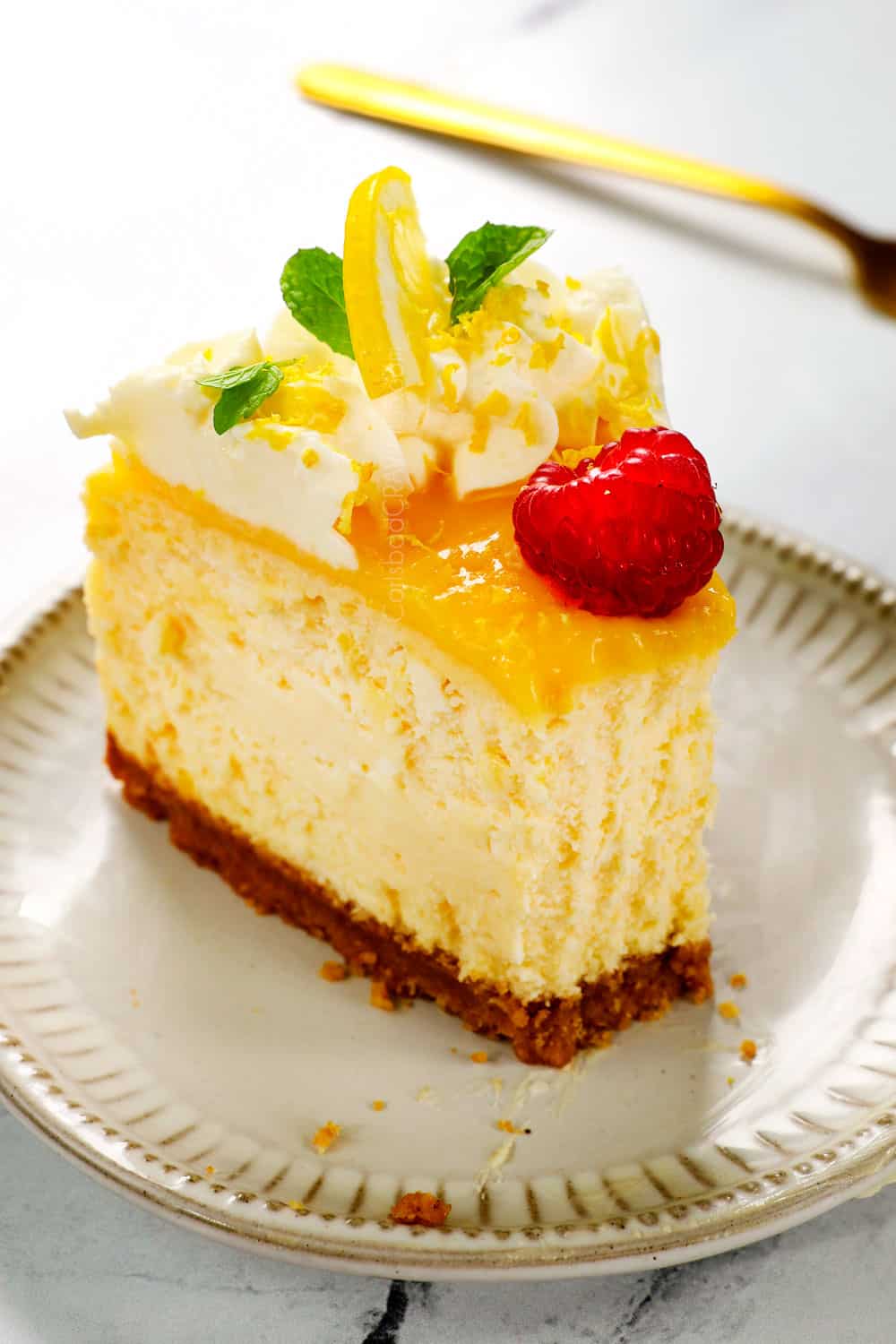 showing how to use lemon curd with up close of creamy lemon curd on cheesecake