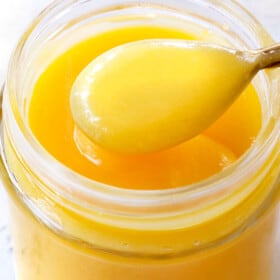 up close of lemon curd in a jar showing how creamy it is