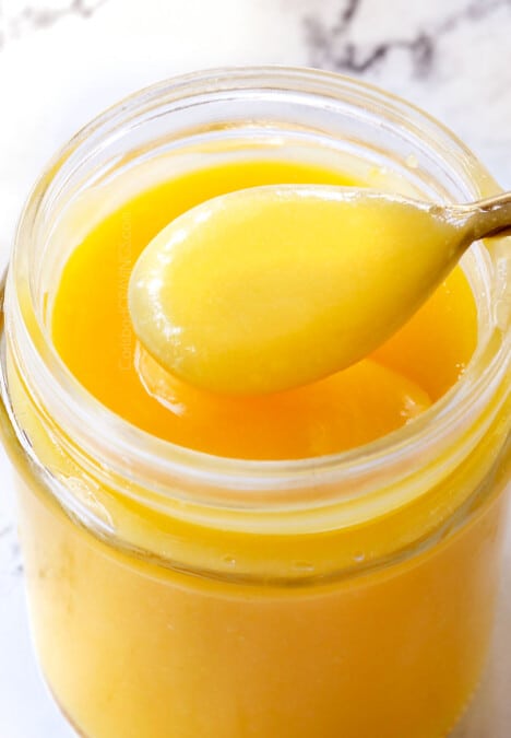 up close of lemon curd in a jar showing how creamy it is