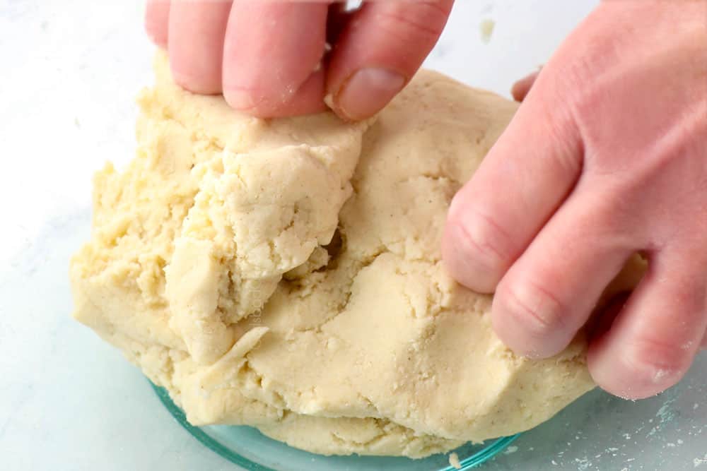 showing how to make corn tortilla recipe by kneading the dough until smooth in a bowl