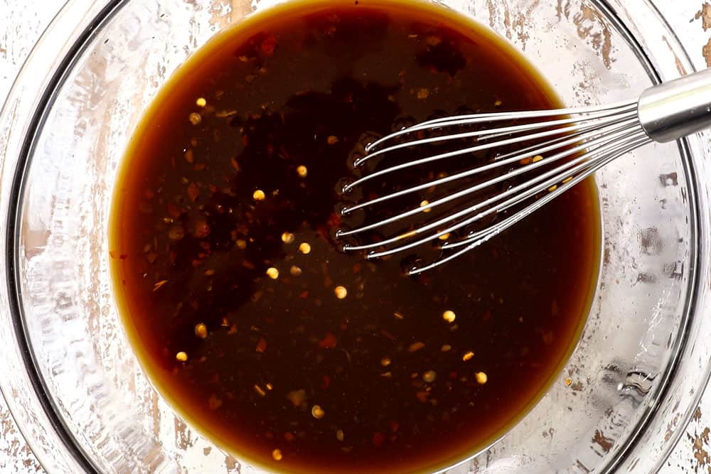 showing how to make ramen noodle stir fry by whisking stir fry sauce together