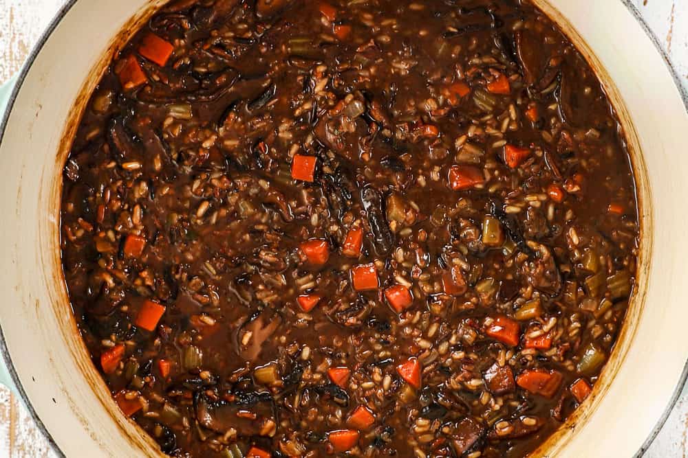 showing how to make mushroom soup by simmering soup until wild rice is tender