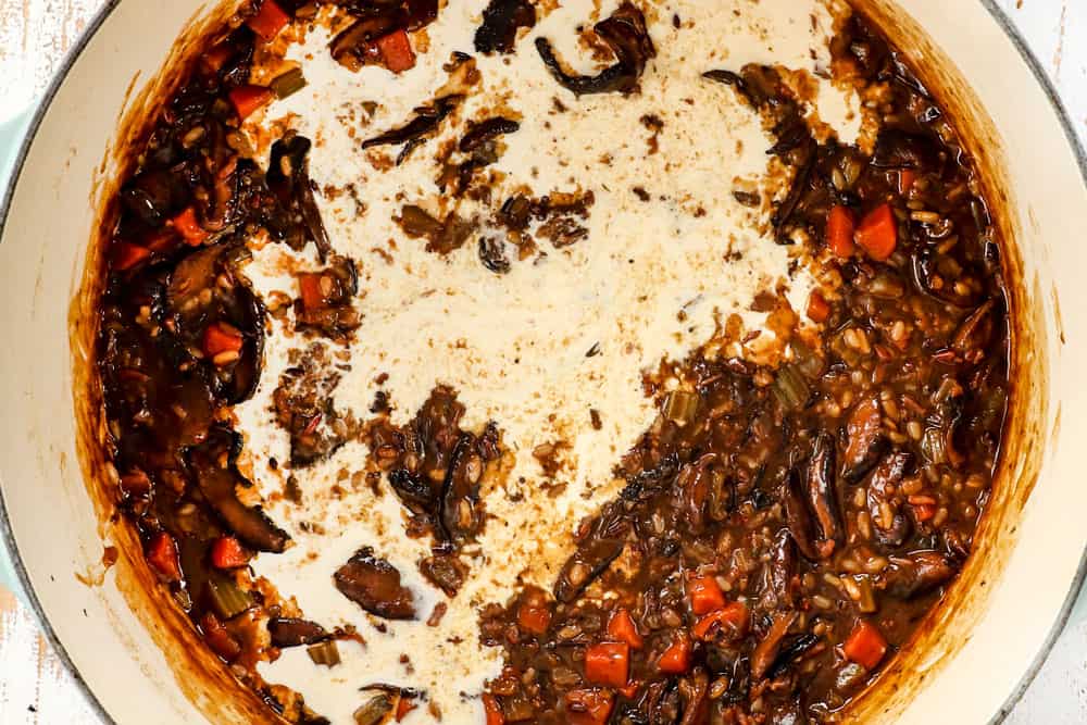 showing how to make mushroom soup by adding half and half to make the soup creamy