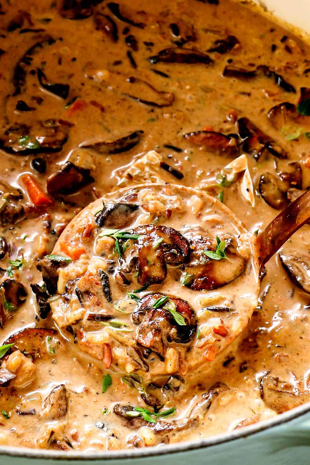 scooping up mushroom soup recipe with a ladle showing how creamy it is