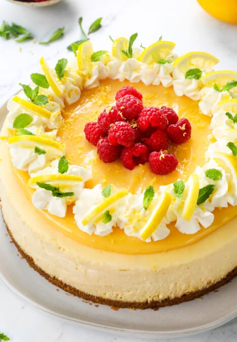 Lemon cheesecake on a white plate with lemon curd topping
