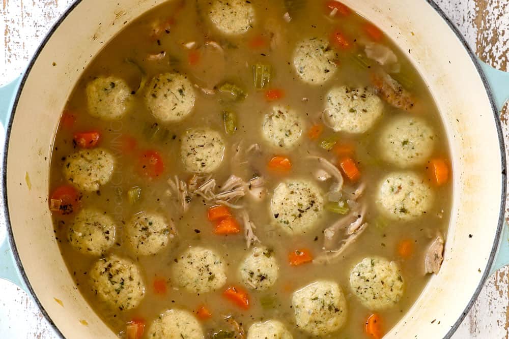 showing how to make matzo ball soup recipe by adding matzo balls to simmering broth