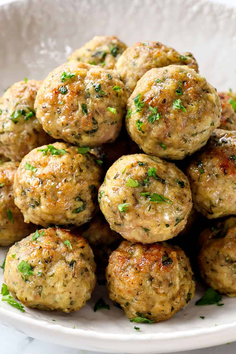 showing how to make Italian Turkey Meatballs by baking until golding