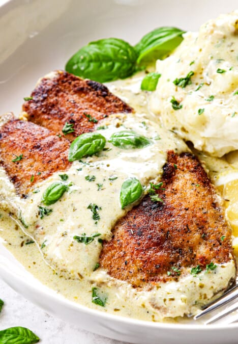 up close of serving tilapia recipe garnished by lemon