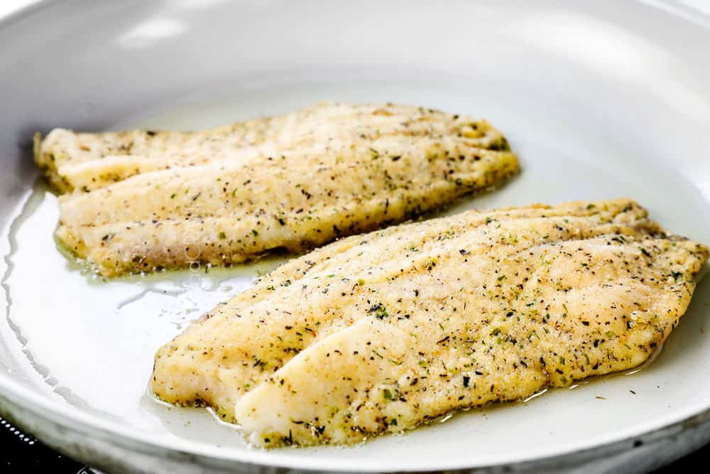 showing how to cook tilapia by pan frying in oil in a skillet