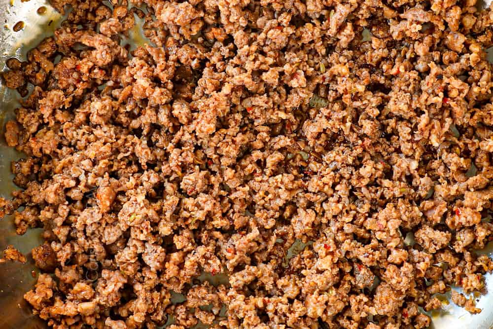 showing how to make Sausage Peppers Pasta recipe by browning Italian sausage in a skillet