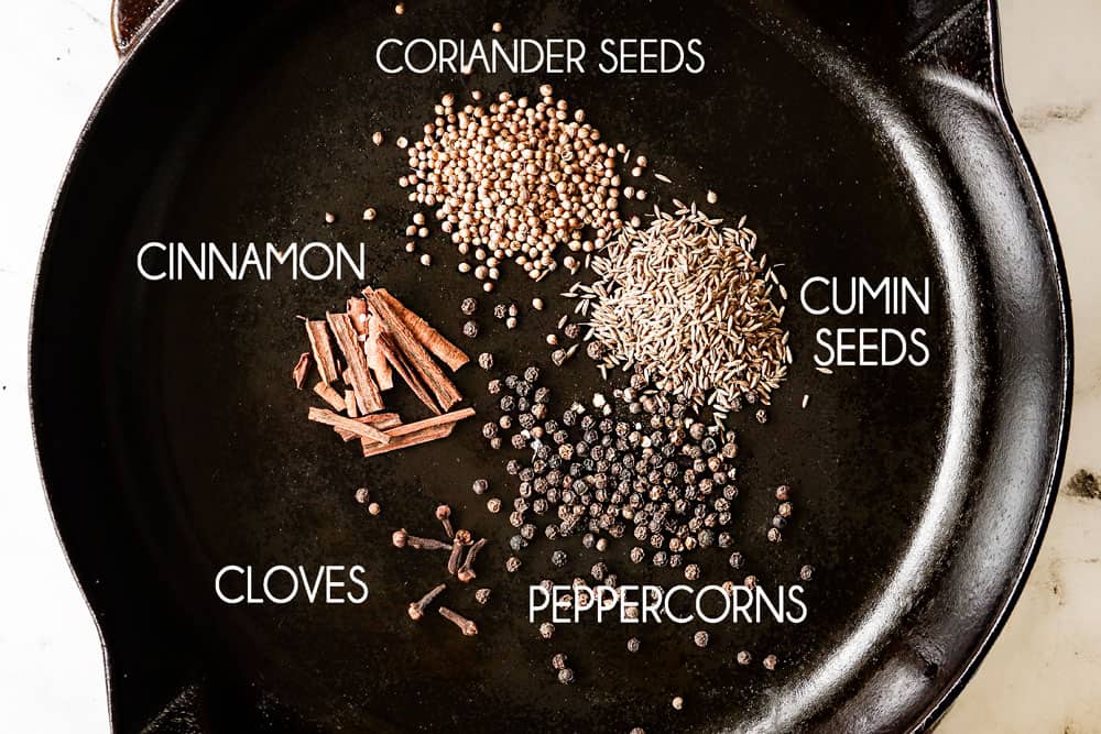 showing how to make adobo sauce by toasting coriander, cumin, cloves and cinnamon in a skillet