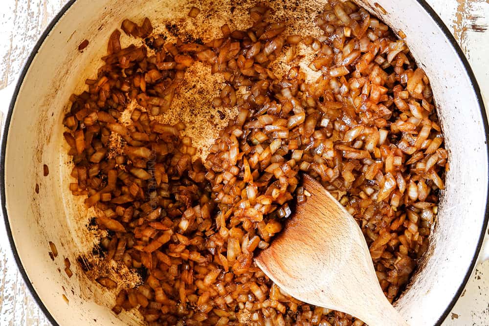 showing how to make chicken birria tacos recipe by sautรฉing onions and garlic in a Dutch oven