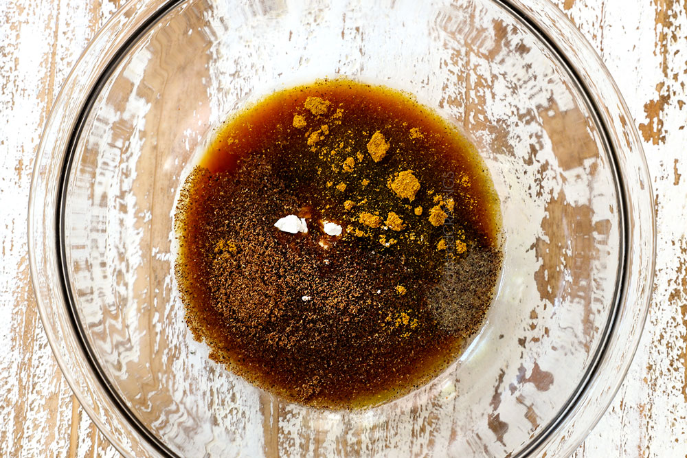 showing how to make Black Pepper Chicken by whisking together soy sauce, oyster sauce and ground pepper to make black pepper sauce