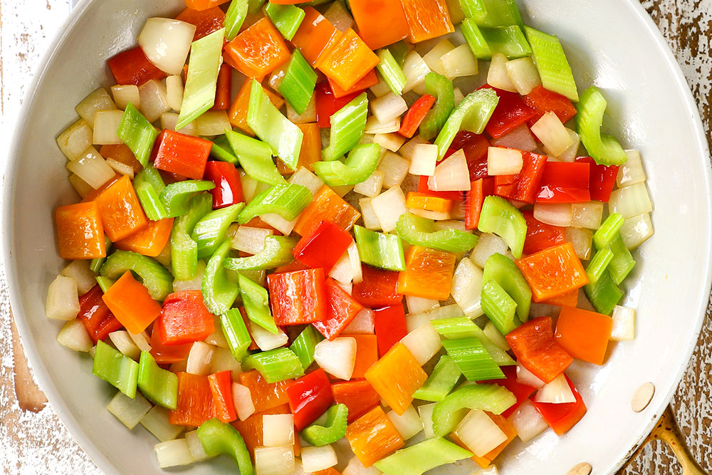 showing how to make Black Pepper Chicken by stir frying bell peppers and celery