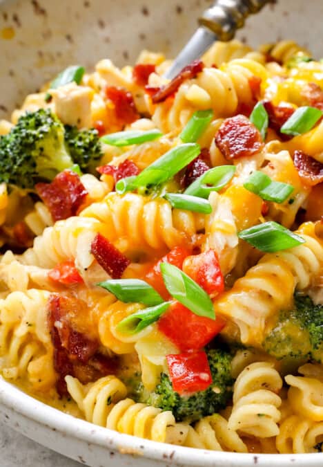 showing how to serve chicken bacon ranch casserole by adding to a bowl and topping with bacon