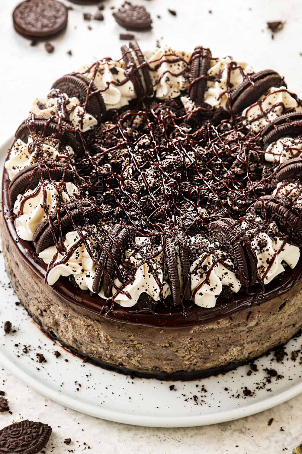 Oreo cheesecake recipe with Oreo crust, crushed Oreos, chocolate ganache and whipped cream