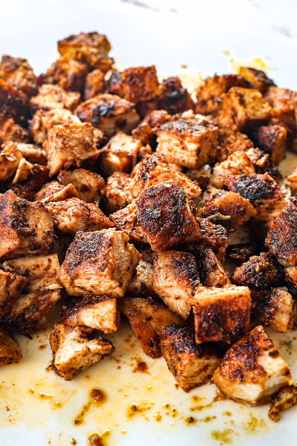 showing how to make Chicken Caesar Pasta Salad by chopping up the chicken