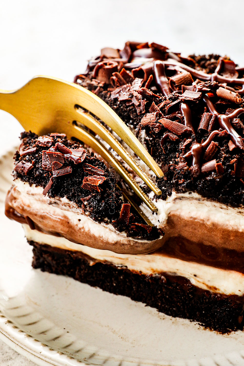 taking a bite out of chocolate lasagna showing how creamy it is