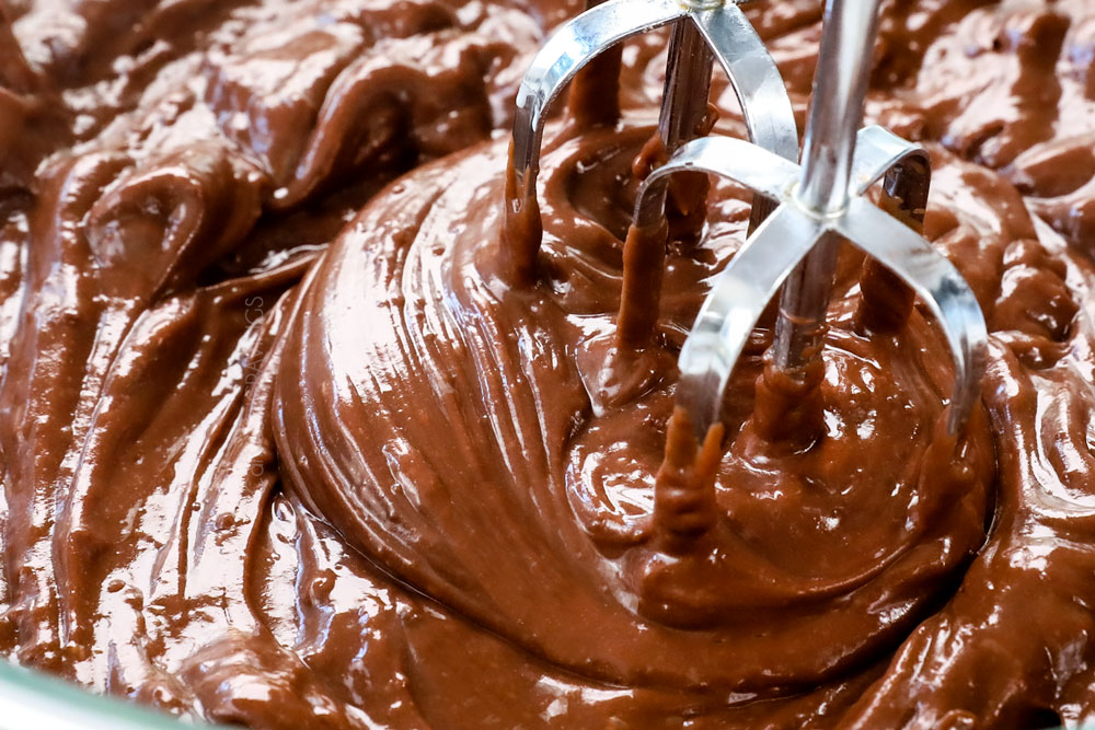 showing how to make chocolate lasagna recipe by beating pudding and milk until smooth