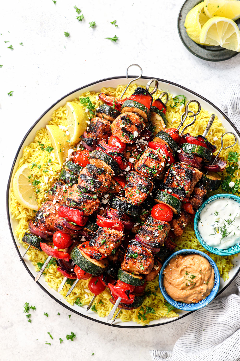 top view of grilled Greek chicken kabobs with tzatziki sauce