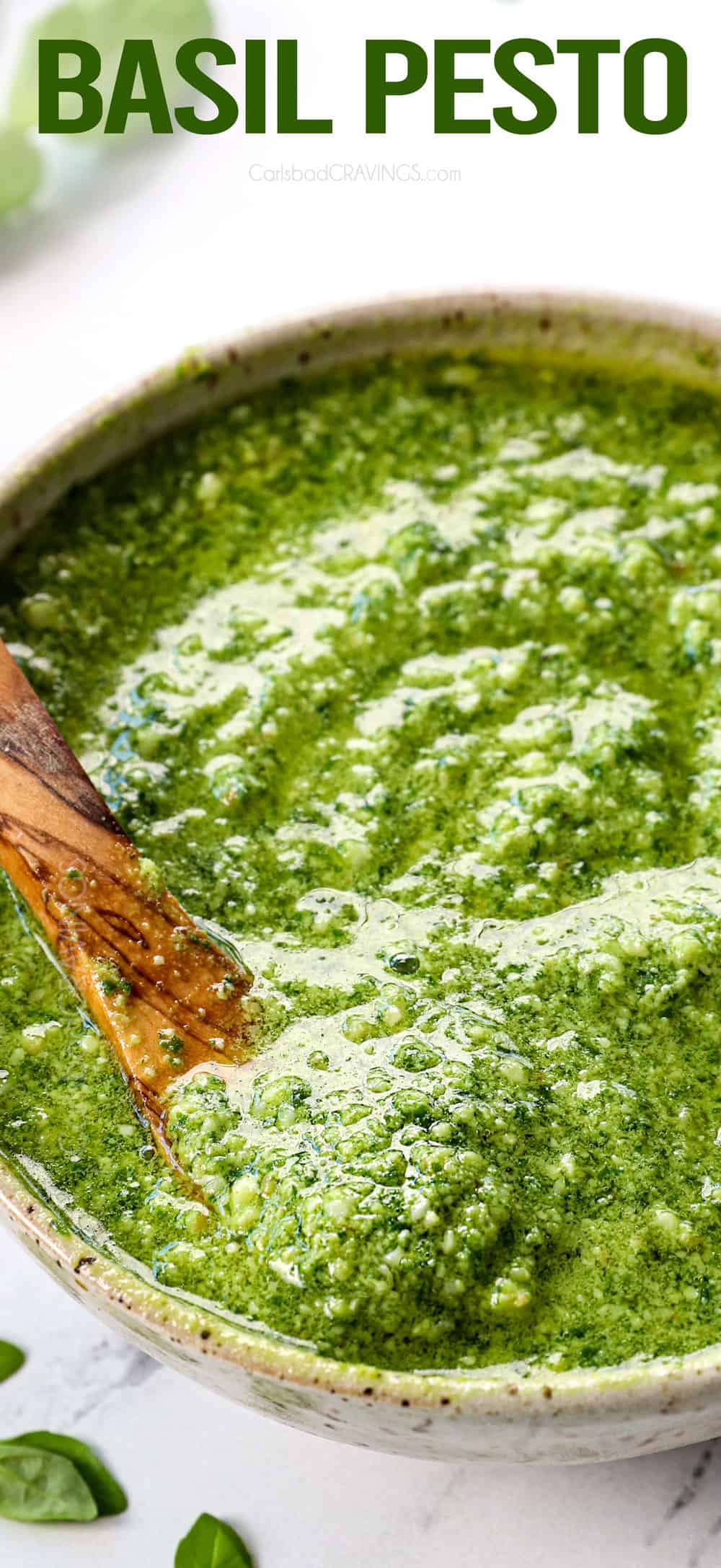 up close of pesto recipe with basil served in a green bowl